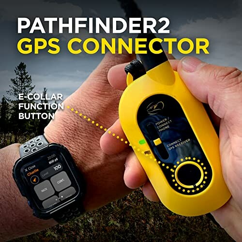 Person holding Pathfinder2 GPS connector and smartwatch with e-collar function.